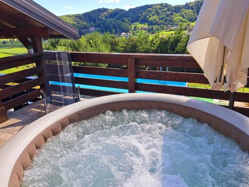 a large hot tub on a patio with a fence at Kuća za odmor MARE in Lepoglava