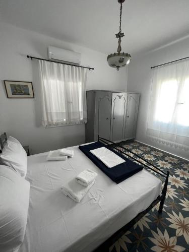 a bedroom with a bed with two towels on it at Elaia House-Eλαία in Spetses