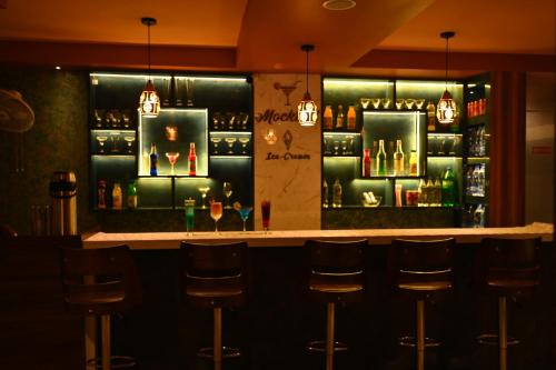 a bar with bar stools in a restaurant at karisma premium in Bhubaneshwar