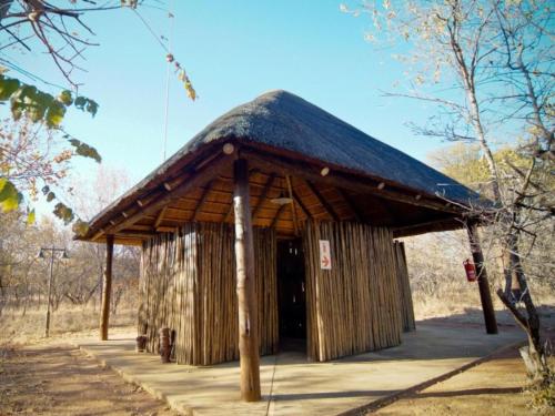 a wooden building with a thatched roof at Mokuru Private Nature Reserve in Brits