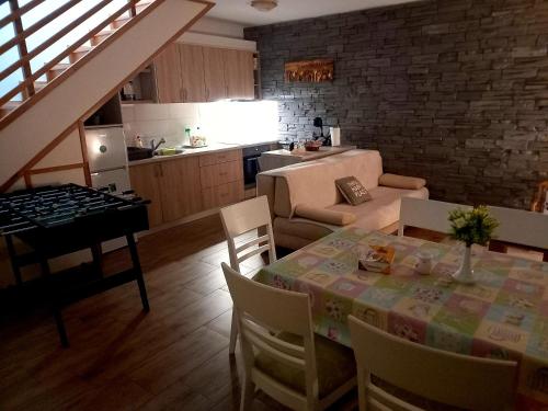 a kitchen and a dining room with a table and chairs at Kuća za odmor MARE in Lepoglava