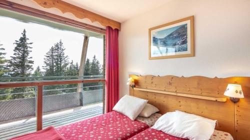 une chambre avec un lit et un balcon dans l'établissement V du Bachat Silene D31 - 6 pers, à Chamrousse
