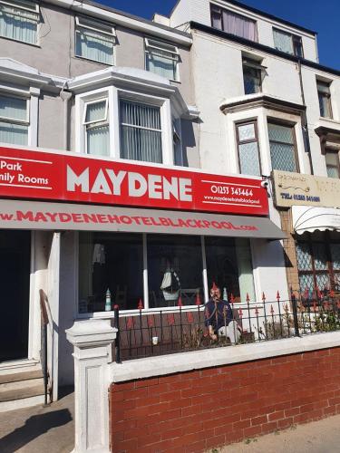 a mayden store with a red sign in front of a building at Maydene Hotel in Blackpool