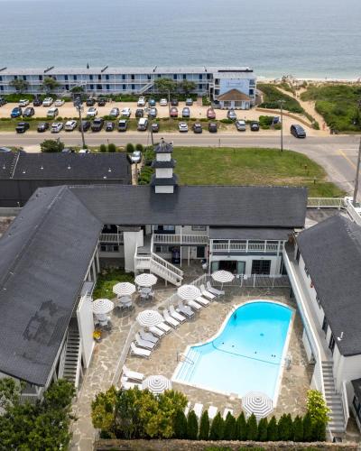 an aerial view of a resort with a swimming pool and the ocean at A Wave Inn - Montauk in Montauk