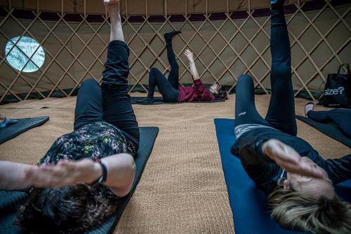 a group of people laying on the floor doing yoga at Montigo Resorts, Somerset in Shepton Mallet
