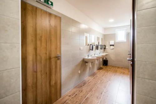 a bathroom with three sinks and two toilets at Ubytování ve Vinařství ZD Němčičky in Němčičky