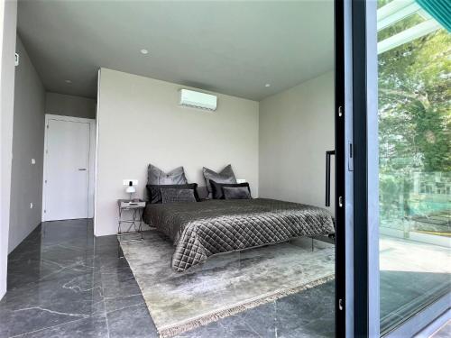アルテアにあるVilla Altea Galesのベッドルーム1室(ベッド1台付)、スライド式ガラスドアが備わります。