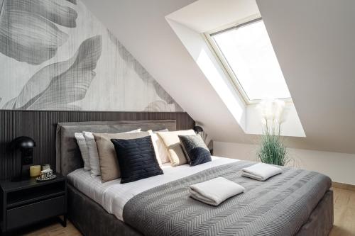 a bedroom with a bed with pillows on it at Muse - LoftAffair Spa Collection in Kraków