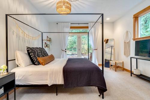 a bedroom with a canopy bed and a window at Brokenbridge Pond in Rhododendron