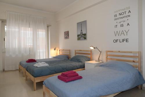 a bedroom with two beds and a sign on the wall at Room in Guest room - Emilios home Triple room in our cozy and comfortable establishment in Rome