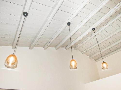 three lights hanging from the ceiling of a room at Antica Dimora Siracusa in Arenella