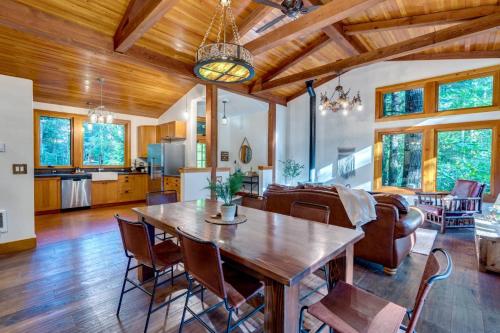 a kitchen and living room with a wooden table and chairs at Tamanawas Cabin in Rhododendron