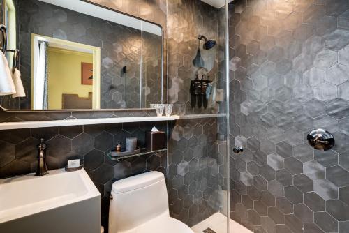a bathroom with a shower and a toilet and a sink at Esme Miami Beach in Miami Beach