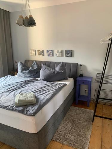 a bedroom with a large bed with blue pillows at HAUS ZWEI in Aspang Markt