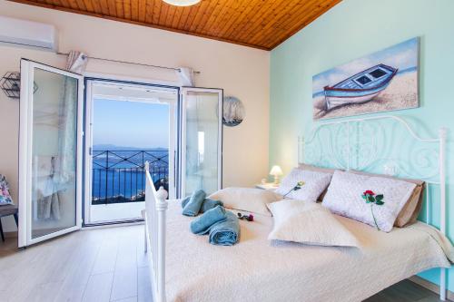 a bedroom with a bed with a view of the ocean at Corfu sight Blue in Spartýlas