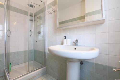 a bathroom with a sink and a shower at PrimoPiano - Euclide in Milan
