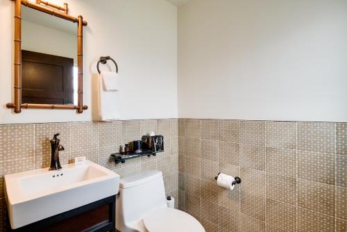 a bathroom with a sink and a toilet and a mirror at Esme Miami Beach in Miami Beach