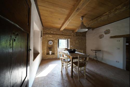 a kitchen with a table and chairs in a room at Agriturismo La Colombella in Bagni San Filippo