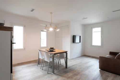 a living room with a dining room table and chairs at Residence Cavalli in Mestre