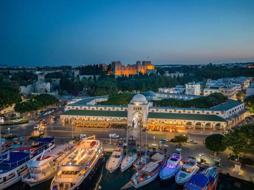 a group of boats docked in a marina at night at Rhodes Youth Hostel in Rhodes Town