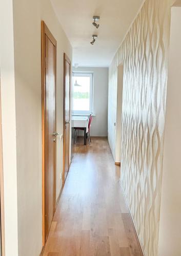an empty hallway with a door and a table at Lakeview Retreat in Vievis in Vievis