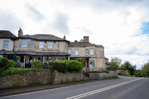 a building on the side of a road at Rising Sun Hotel by Greene King Inns in Cheltenham