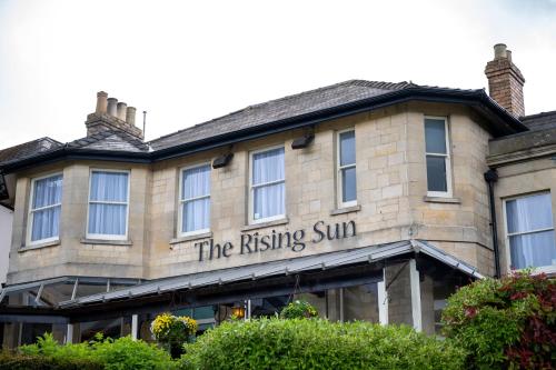 a building with the rising sun written on it at Rising Sun Hotel by Greene King Inns in Cheltenham