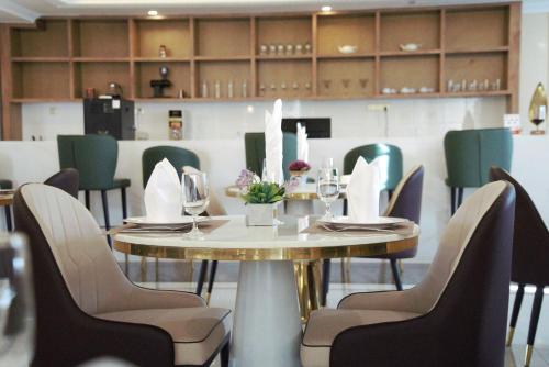 a dining room with a table and chairs at ST Hotel Wattay Airport in Vientiane