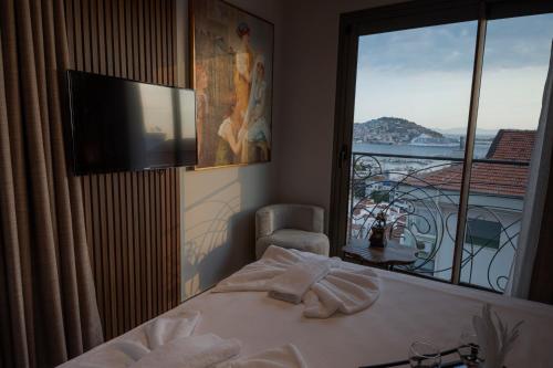 a bedroom with a bed and a window with a balcony at Monalisa Hotels KUŞADASI in Kusadası