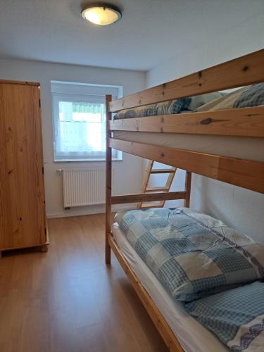 a bedroom with two bunk beds and a window at Ferien im Bergischen in Reichshof 