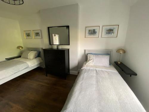 a bedroom with two beds and a mirror at mary-tim's Cromane Cross near Killorglin in Killorglin