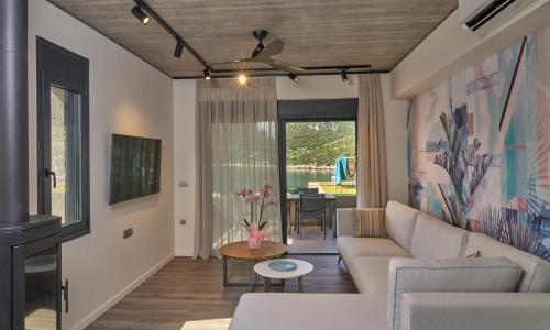 a living room with a couch and a table at Into The Blue Suites in Arkadiko Chorio
