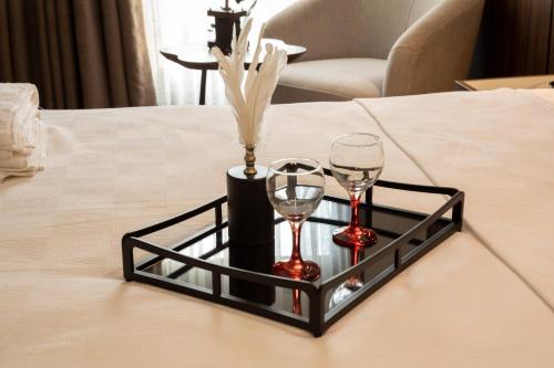 a black tray with two wine glasses on a table at Monalisa Hotels KUŞADASI in Kusadası