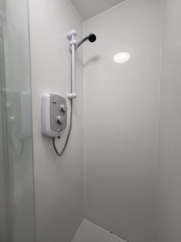 a shower stall with a soap dispenser in a bathroom at Quiet Room Near Arsenal Stadium Islington Zone 2 Cental in London