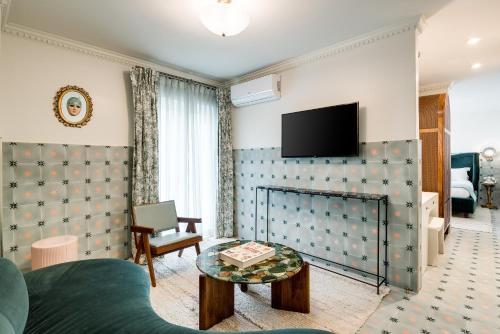 a living room with a bed and a tv on a wall at Esme Miami Beach in Miami Beach