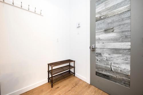 a room with a wooden wall and a door at HoMa Homestay Hotel by Olympic Stadium Montreal Auberge-Hostel in Montréal