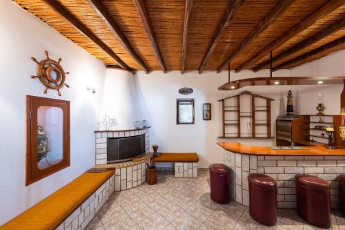 a living room with a bar and a tv at The Eagle's Nest house - overlooking Antiparos in Kamári