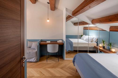 a bedroom with a bed and a desk in a room at Dimora Condivi in Ripatransone