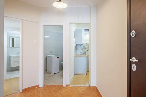 a room with a hallway with a mirror and a bathroom at Spacious 3 bedroom apt in Eksarchia in Athens