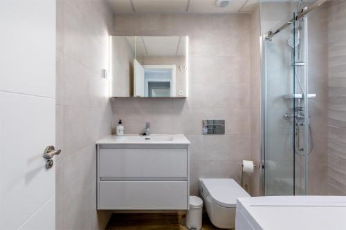 a bathroom with a sink and a toilet and a shower at A&N Sea View Apartment with Pool & Parking Torre del Mar in Torre del Mar