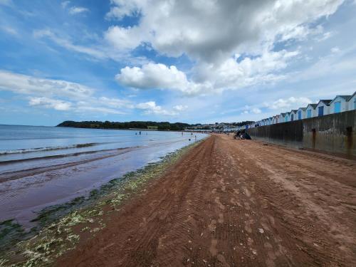 a beach with a dirt road next to the water at Seaspot is a 1 bed annex ground floor apartment at stunning Broadsands Beach nr Brixham! in Churston Ferrers