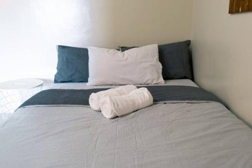 a white towel sitting on top of a bed at Spacious and Cozy 1-Bedroom Condo at Brenthill in Baguio