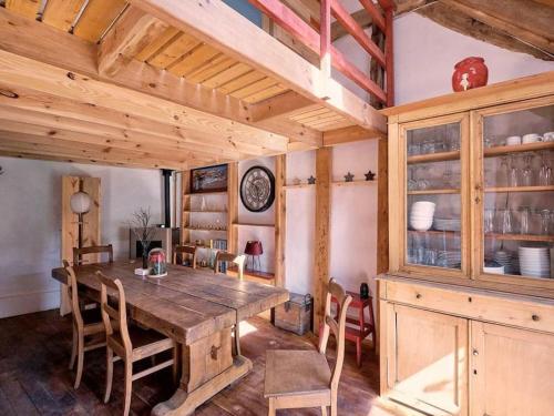ein Esszimmer mit einem Holztisch und Stühlen in der Unterkunft Le Forgite - Gîte de charme in Matagne-la-Petite