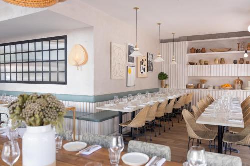 a dining room with white tables and chairs at Esme Miami Beach in Miami Beach