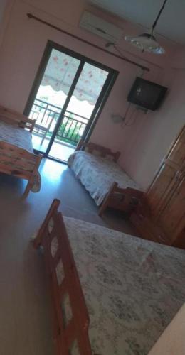 a bedroom with a bed and a large window at Old House On The Beach Asprovalta 1 in Asprovalta