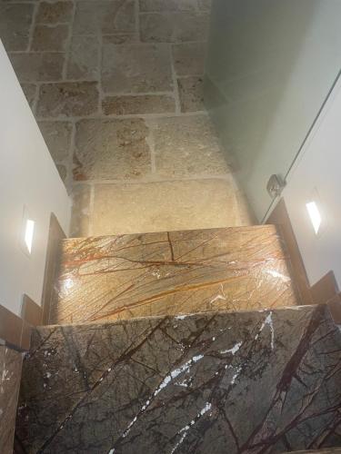 a bathroom with a stone floor with a counter top at Villa Romina in Selva di Fasano