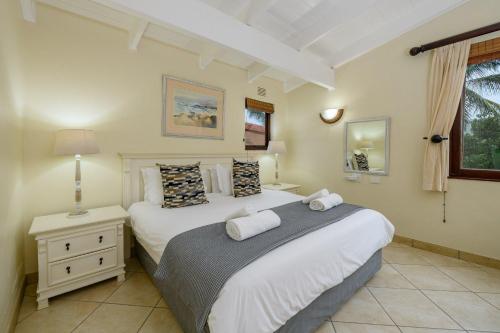 A bed or beds in a room at San Lameer Villa 3007 - 4 Bedroom Superior - 8 pax - San Lameer Rental Agency