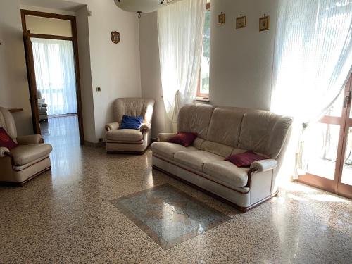 a living room with two couches and two chairs at Villa Belvedere in Susa