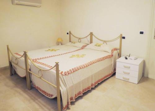 a bedroom with a large bed with a dresser and a night stand at Villa Mare in Forte dei Marmi