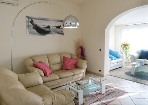 a living room with a couch and a table at Villa Mare in Forte dei Marmi
